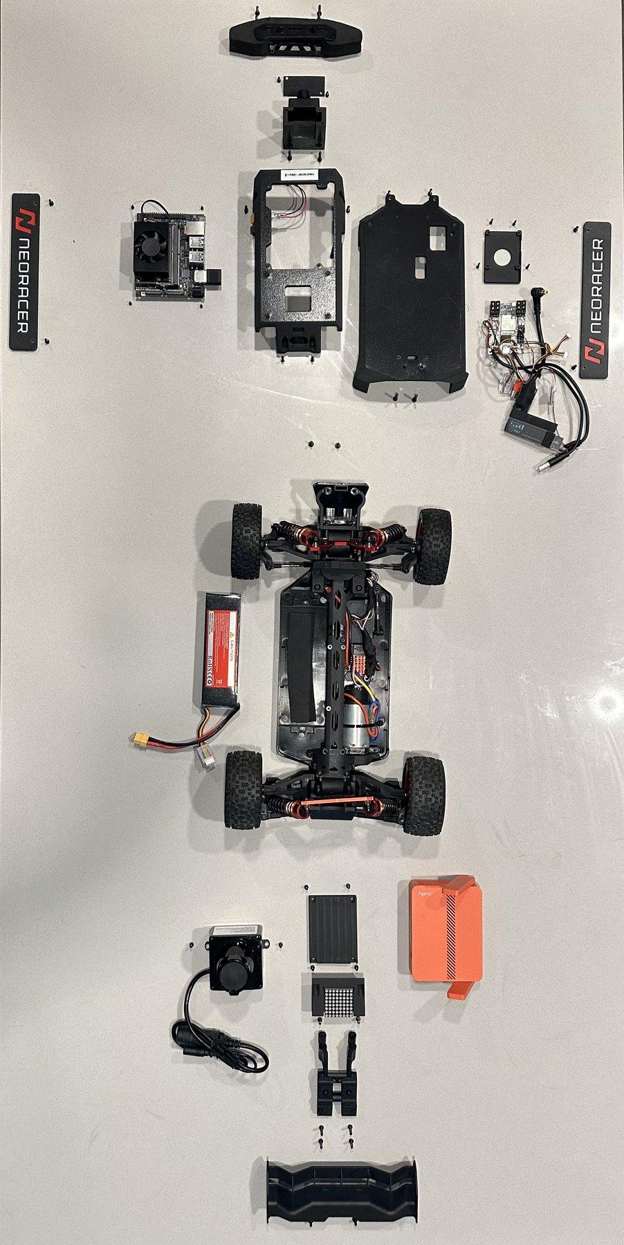 The NeoRacer torn down: every component laid out around the bare chassis, photographed from above
