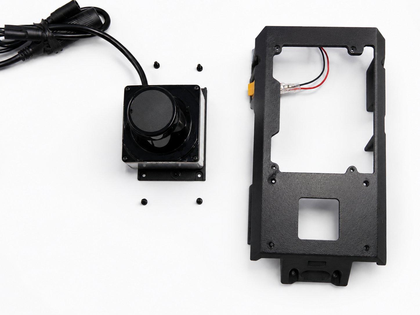 The LiDAR unit and its four screws beside the printed top plate
