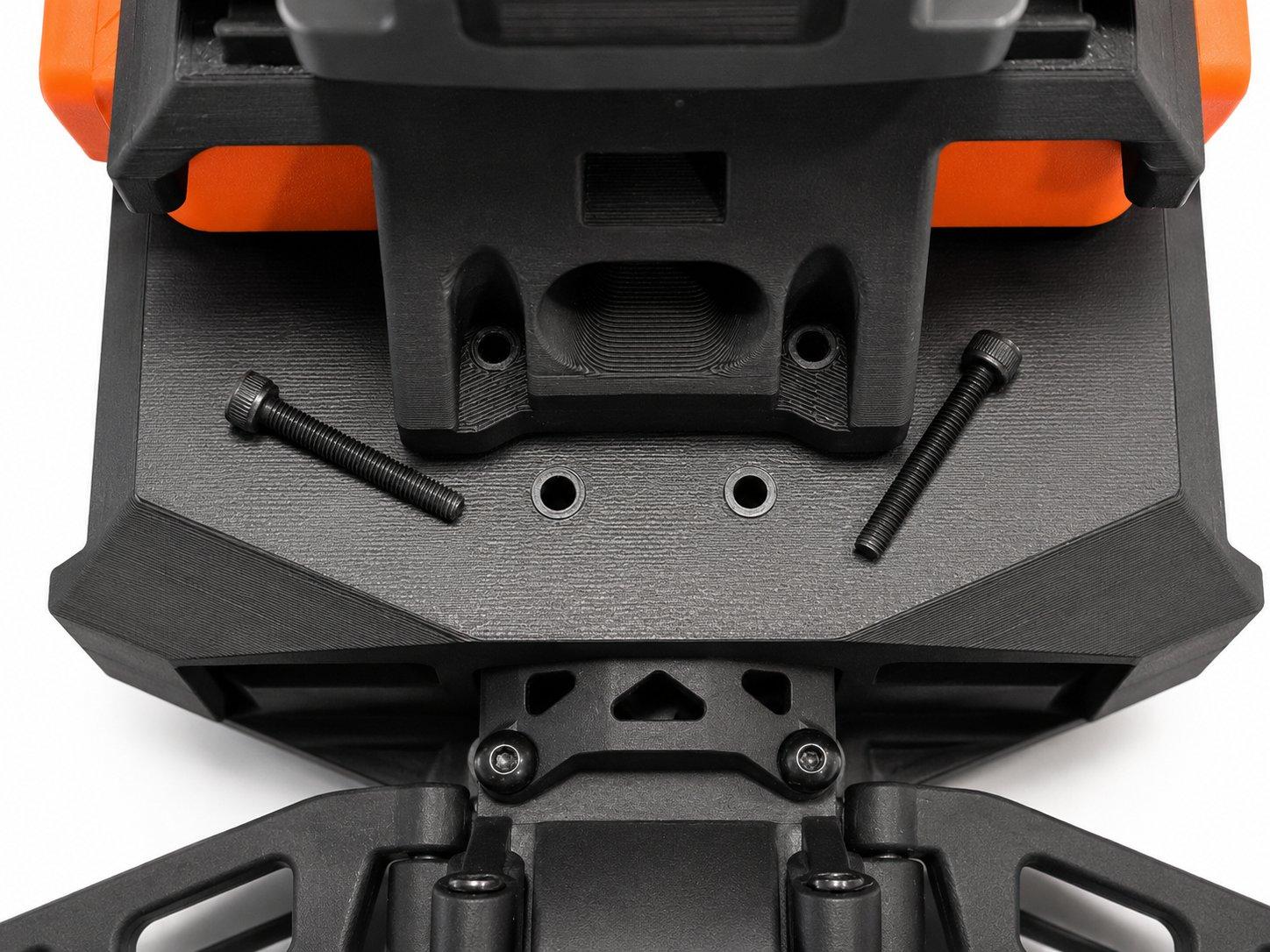 The two long screws on the rear deck that fasten the lower printed section to the chassis