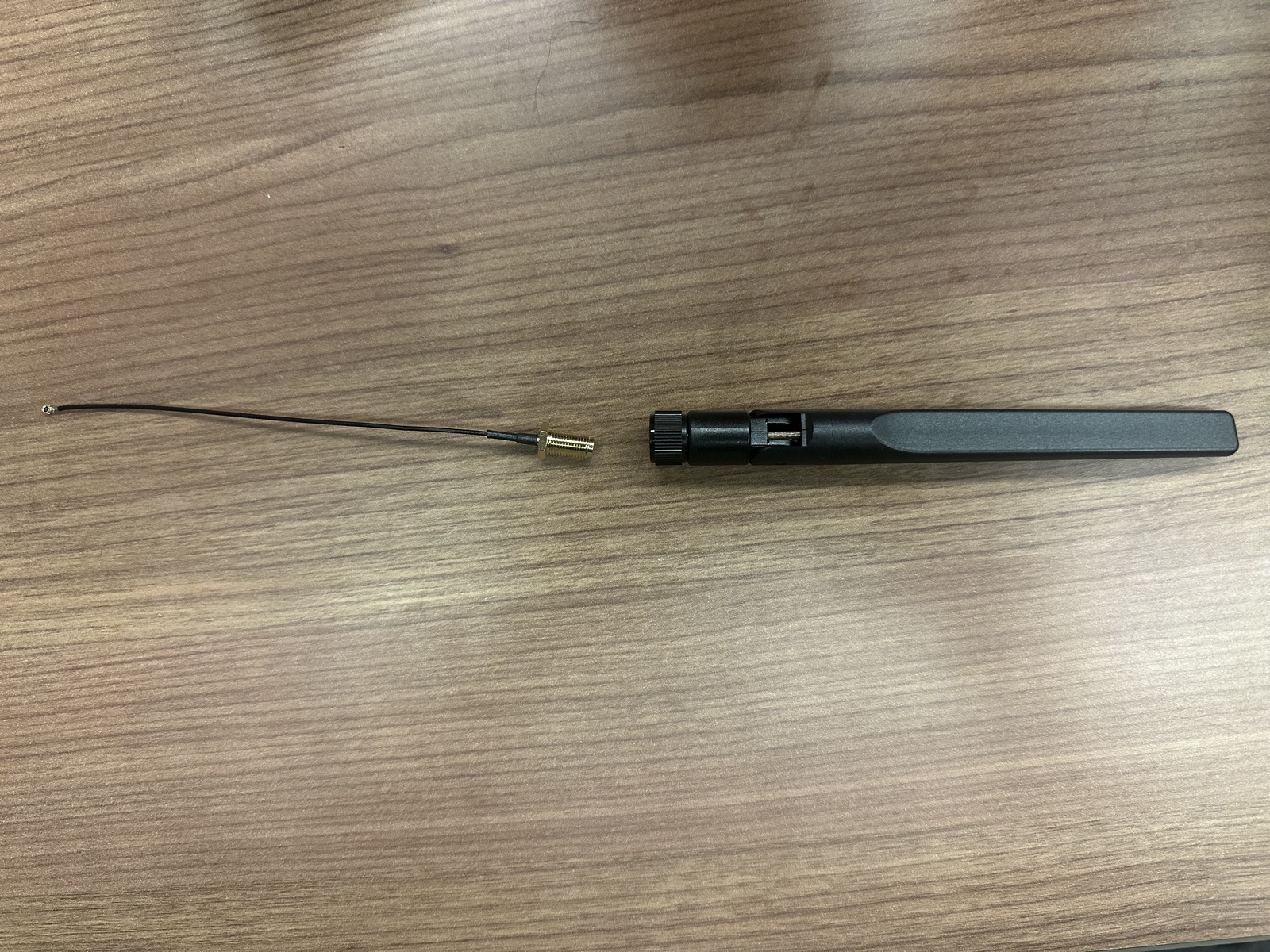 Click to enlarge An antenna cable next to the plastic antenna that screws onto it