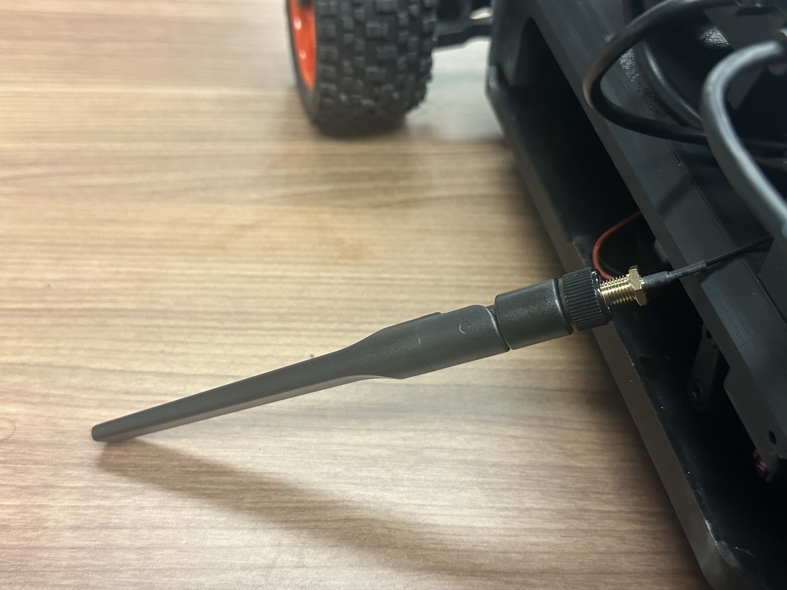 Click to enlarge A plastic antenna screwed onto the cable at the side of the car