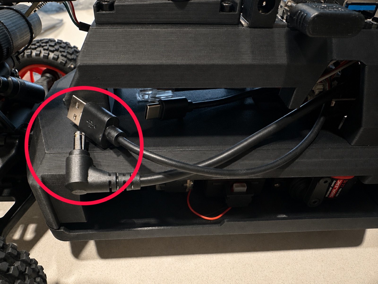 Click to enlarge The USB-A and DC barrel jack cables on the right side of the car