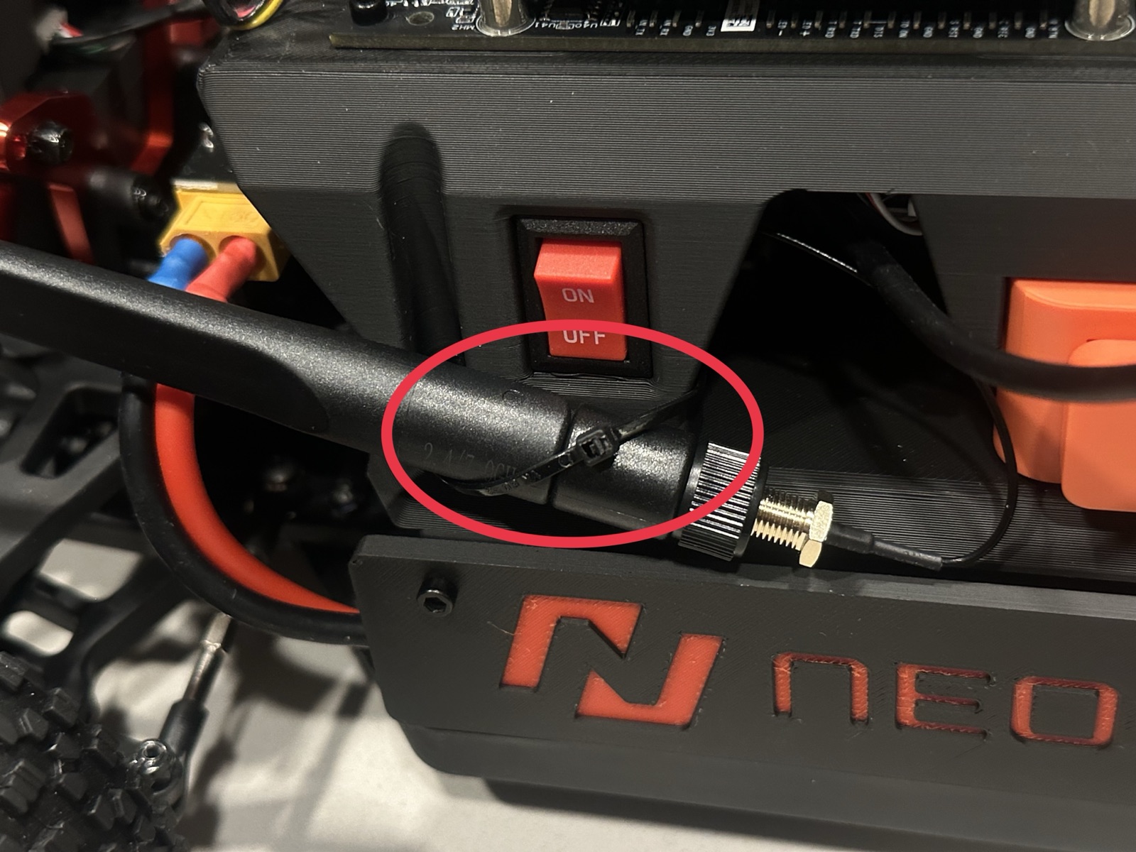 Click to enlarge The left antenna zip-tied to the front of the top chassis by the on/off switch